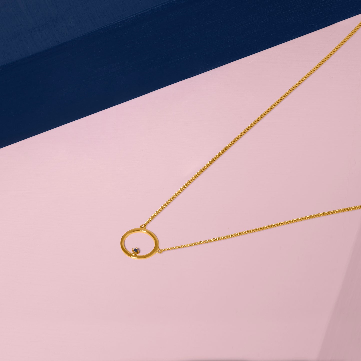 Free To Roam Necklace Gold Styled On Pink and Blue 